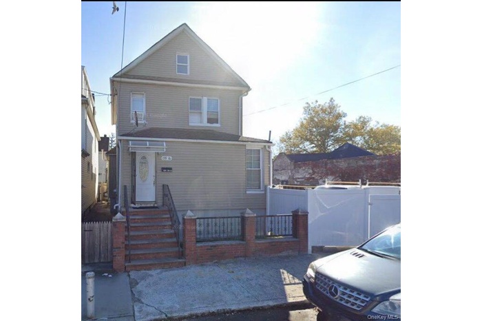American foursquare style home with a fenced front yard