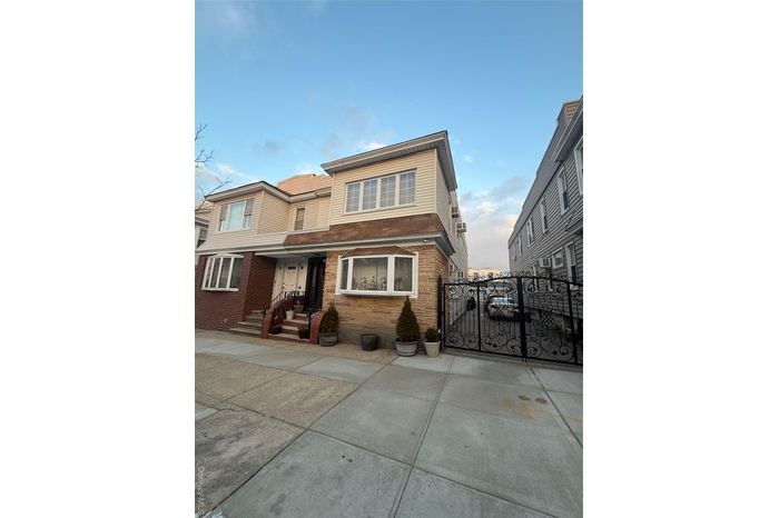 Traditional-style house featuring a gate