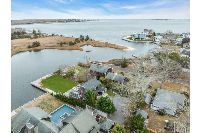 Aerial perspective of suburban area featuring a large body of water