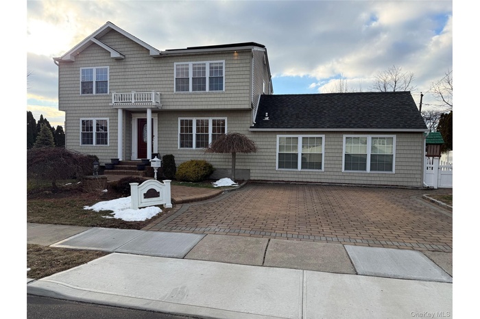 View of front of house featuring a shingled roof
