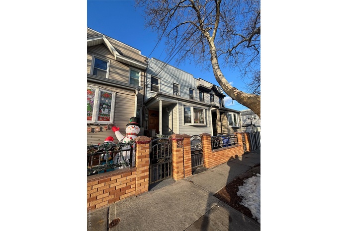 Traditional-style house with a gate and a fenced front yard