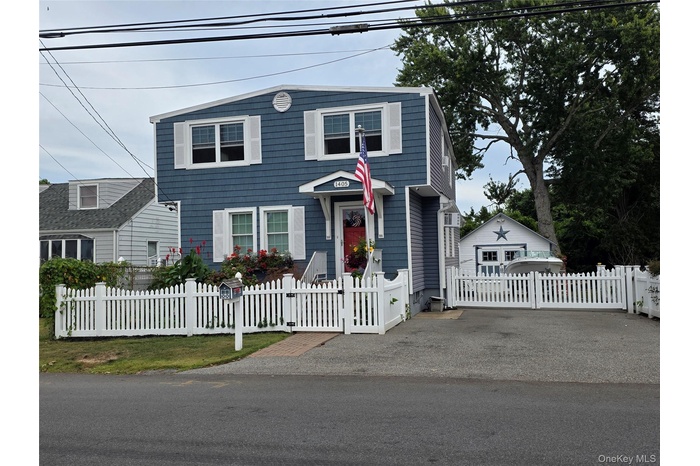 View of front of house with a fenced front yard and a gate