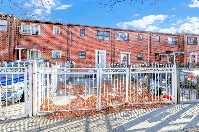 View of front of home featuring a fenced front yard and a gate
