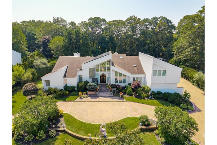 View of front of property with a chimney and stucco siding
