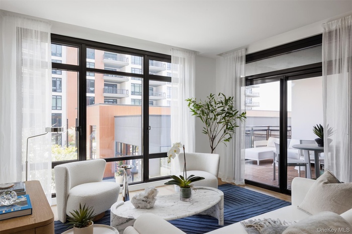 Living area with plenty of natural light and wood finished floors