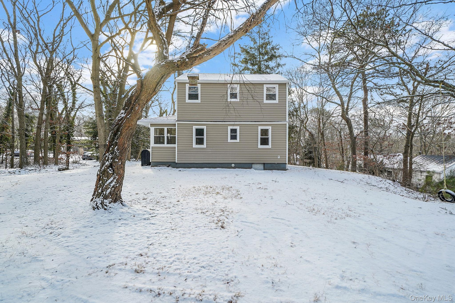 View of snow covered back of property