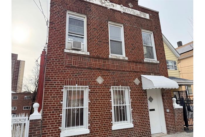 View of front of house featuring brick siding