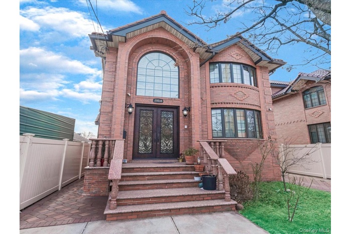 Property entrance featuring french doors and brick siding
