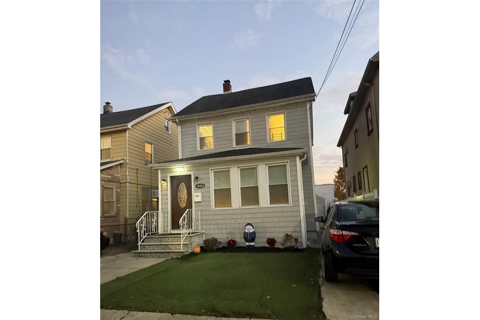 View of front facade featuring a chimney
