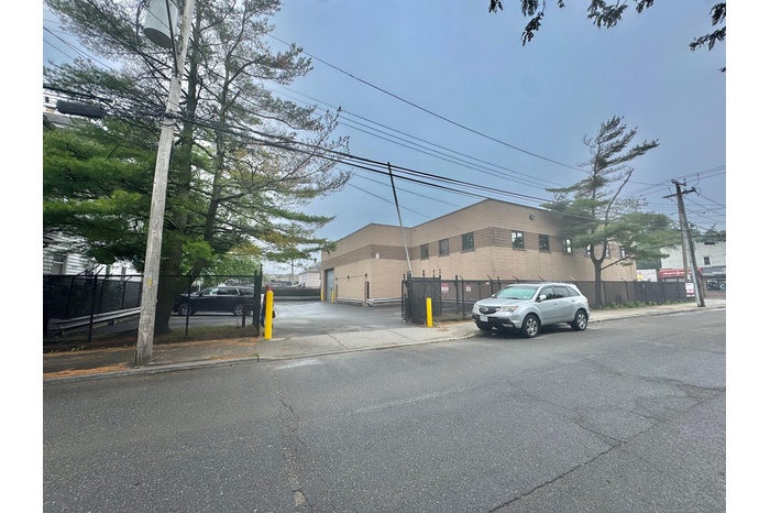 View of asphalt street featuring sidewalks and curbs