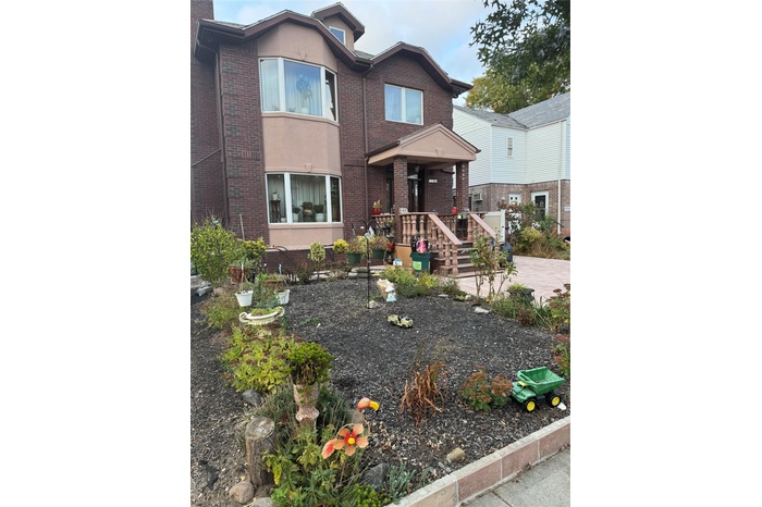 View of front of house with brick siding