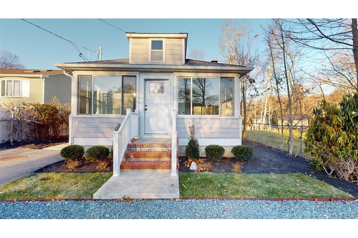 Welcoming brick entry leads to the spacious, very functional, warm & inviting sunroom!