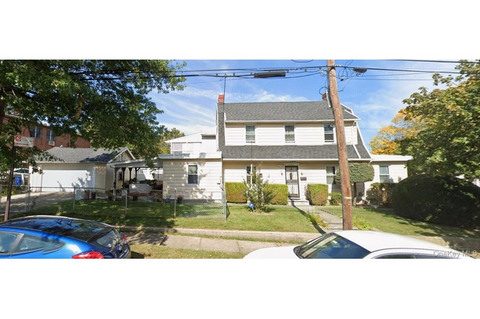 View of front of property featuring roof with shingles and a chimney