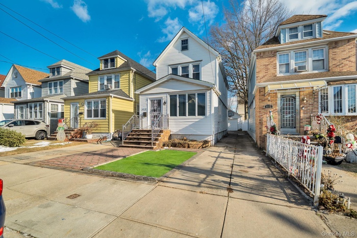 American foursquare style home featuring a residential view, brick siding, and driveway