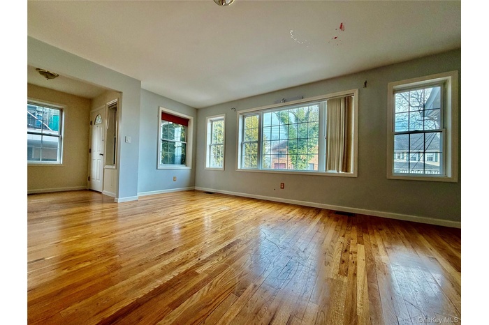 Empty room with baseboards and light wood-style floors