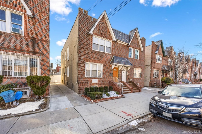View of front of home featuring brick siding