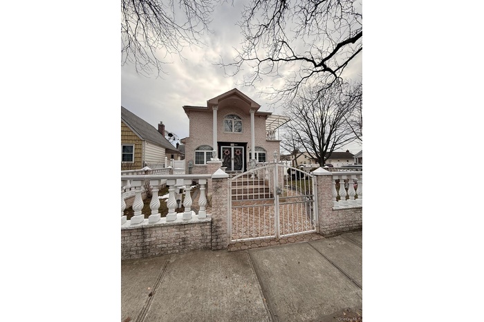 View of front facade featuring a gate and a fenced front yard