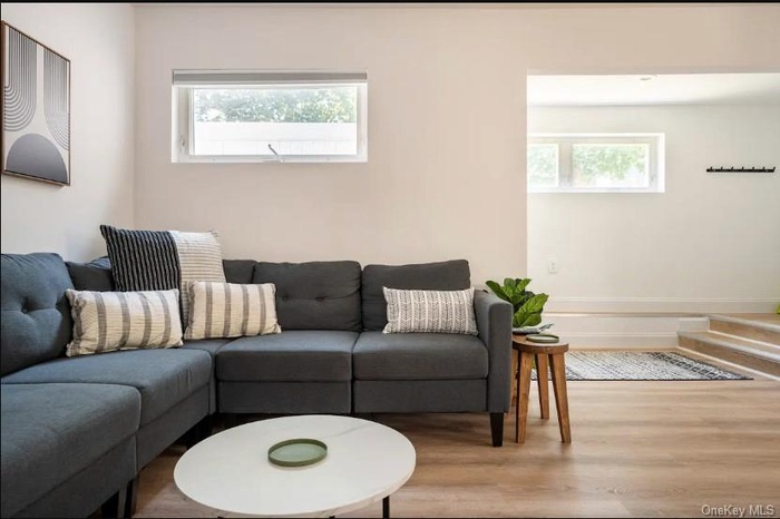 Living area with wood finished floors and plenty of natural light