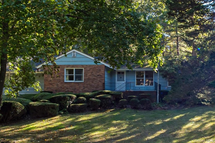 View of front of home featuring brick siding and a front lawn