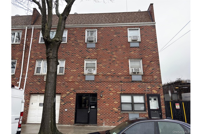 View of apartment building / complex featuring a garage