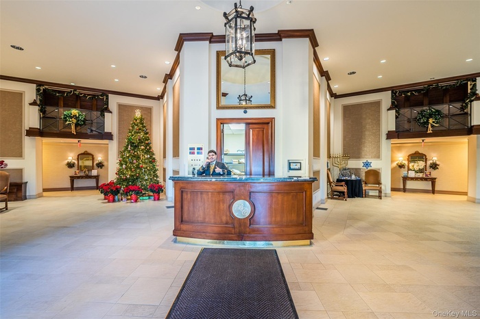 Reception featuring ornamental molding and recessed lighting