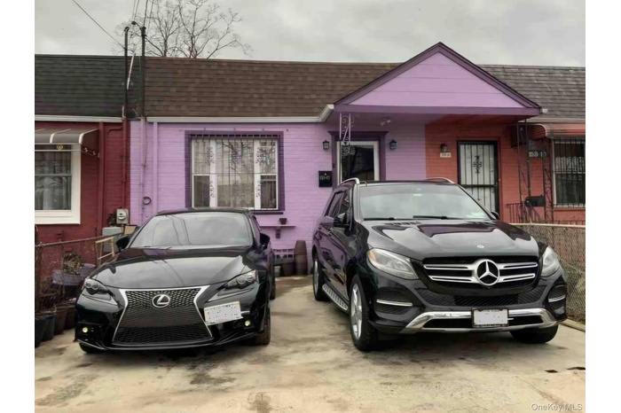Bungalow-style house with roof with shingles and brick siding