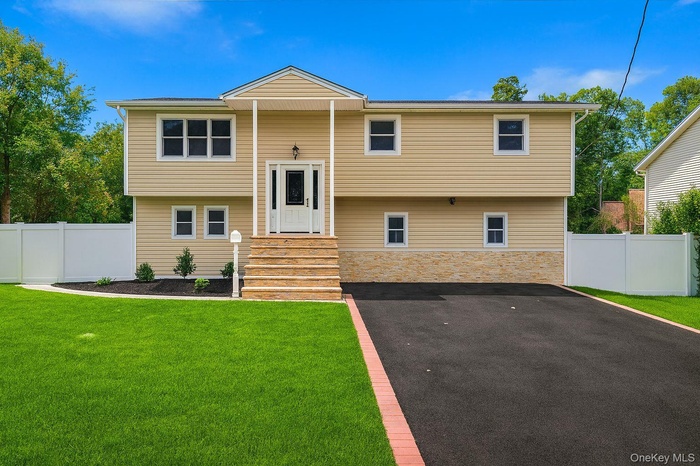 Raised ranch featuring stone siding