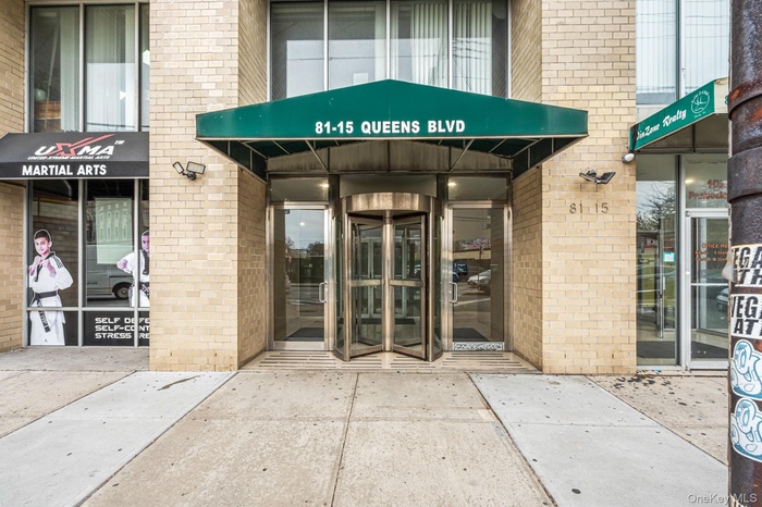Doorway to property featuring brick siding