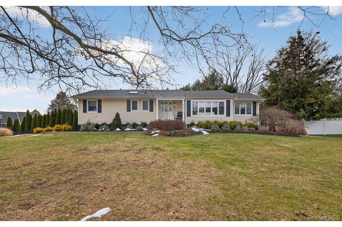 Single story home with a front lawn