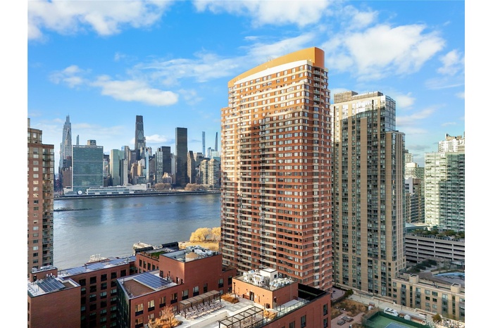 View of city skyline featuring a nearby body of water