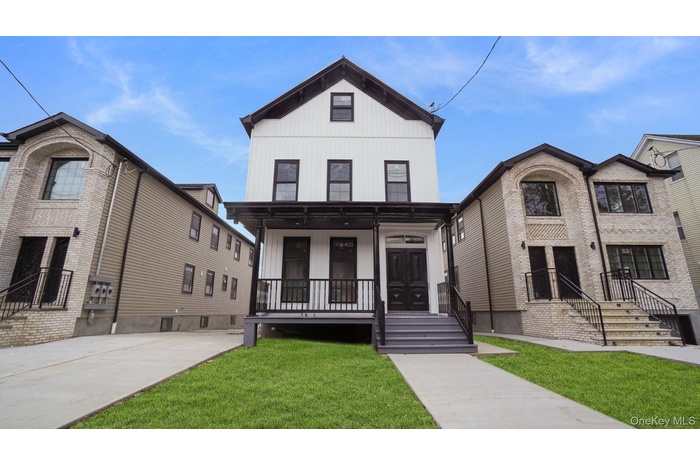 View of front of home featuring a front yard and a porch