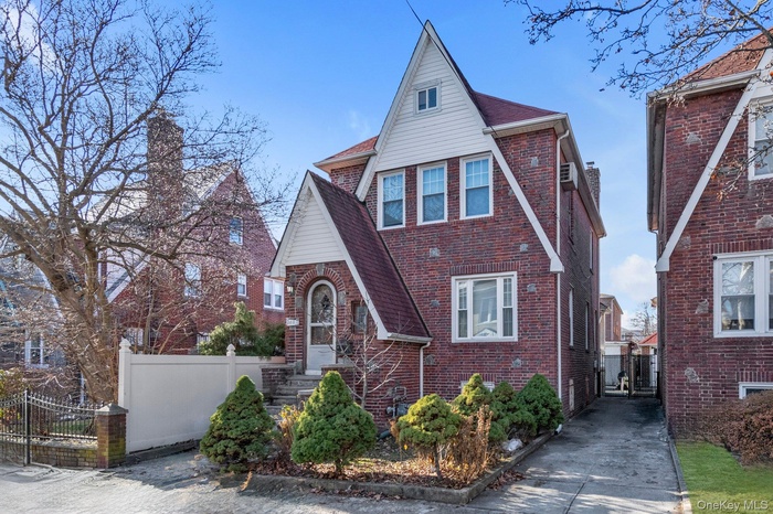 Tudor house with brick siding and a shingled roof