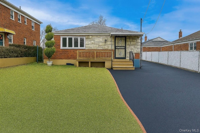Rear view of property featuring stone siding
