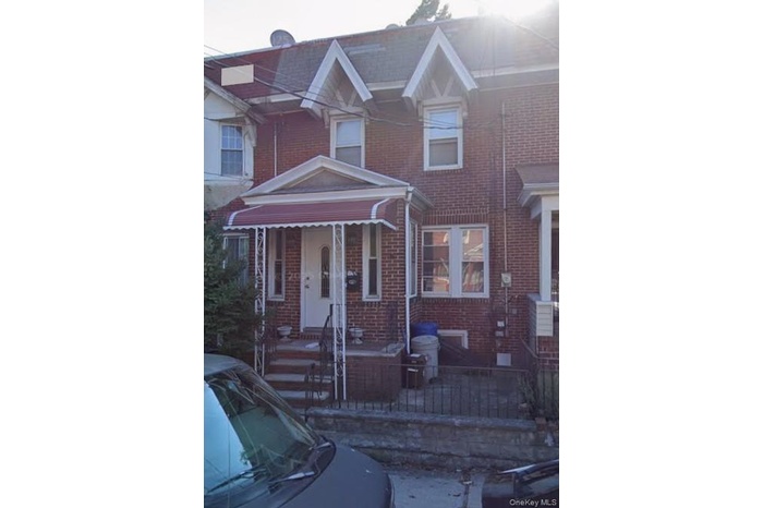 View of front of house with covered porch and brick siding