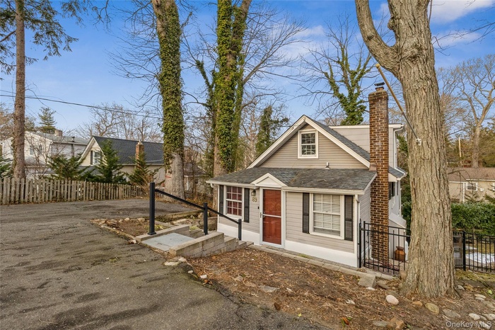 Front view featuring large parking area.