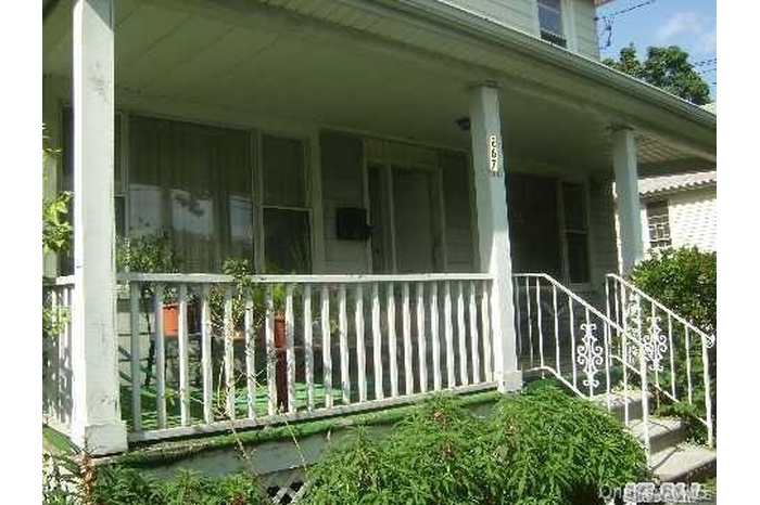 View of property exterior featuring covered porch