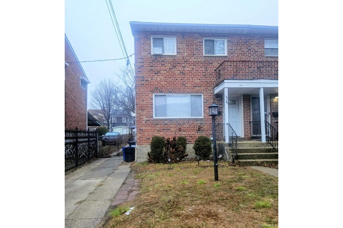 Traditional-style home featuring brick siding