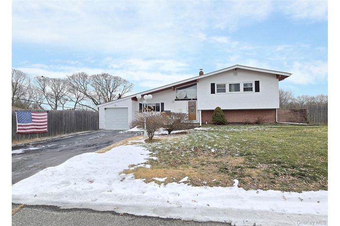 View of front of home featuring driveway and an attached garage