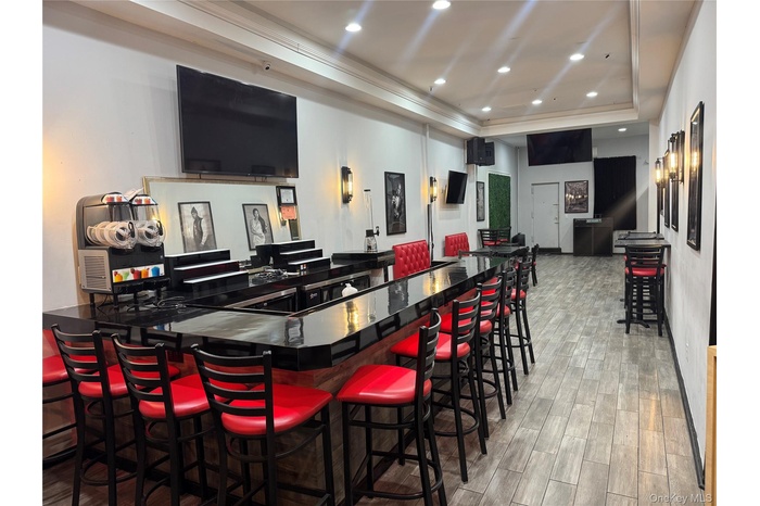 Community bar area featuring recessed lighting, dark countertops, and crown molding
