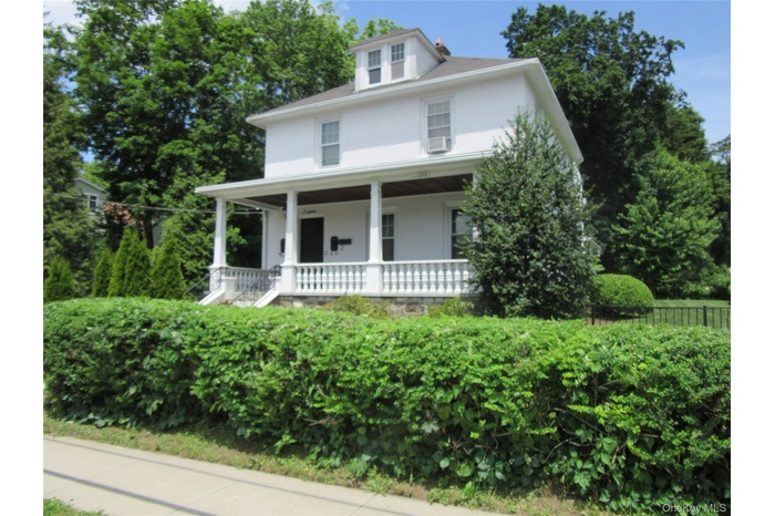 View of front facade featuring a porch and stucco siding