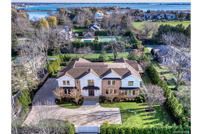 Aerial perspective of suburban area featuring a large body of water