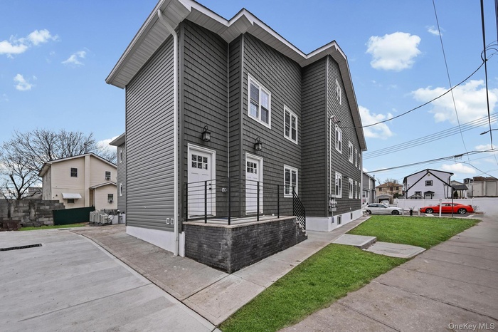 View of side of property featuring a lawn
