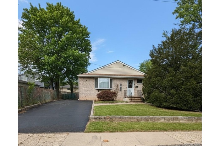 View of front of property featuring brick siding and driveway