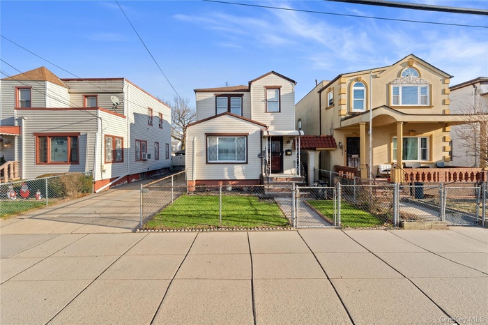 Traditional-style house with a gate, a fenced front yard, cooling unit, and a porch