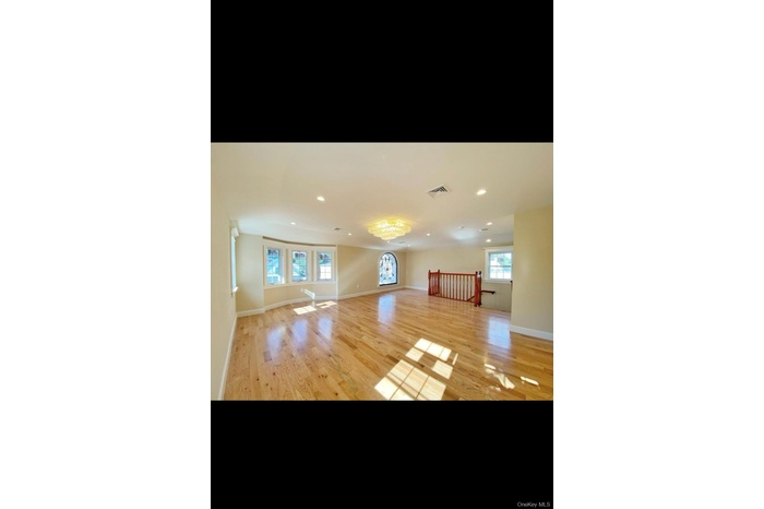 Unfurnished living room featuring recessed lighting, light wood-style floors, and a chandelier