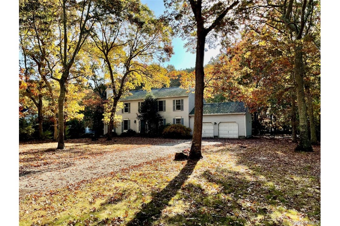 Colonial-style house featuring a garage