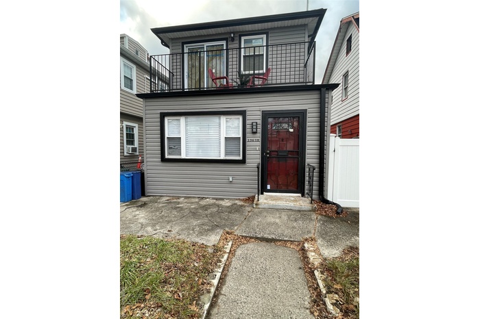 View of front of house with a balcony