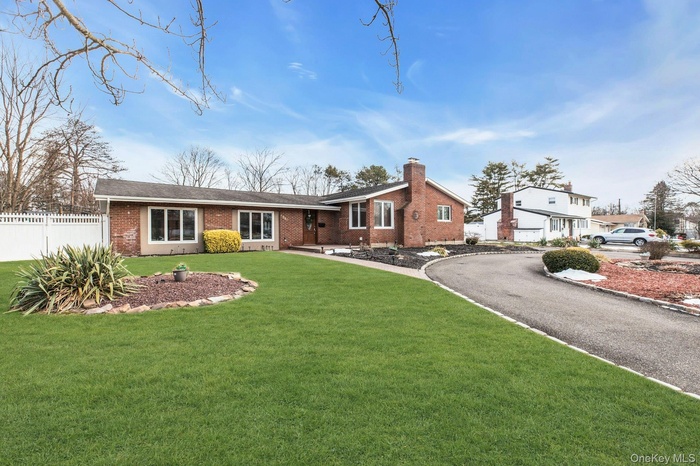 Single story home featuring brick siding and a chimney