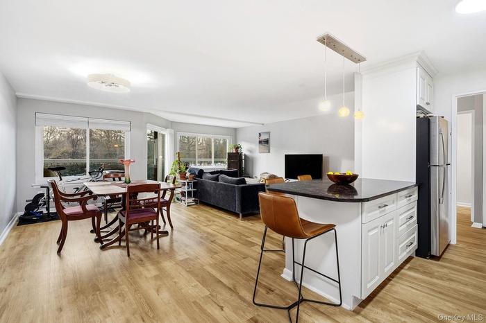 Dining area with light wood-style floors