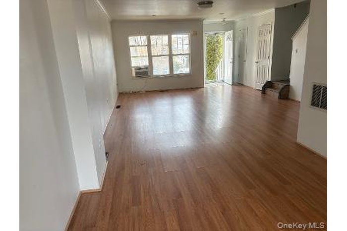 Unfurnished living room with wood finished floors